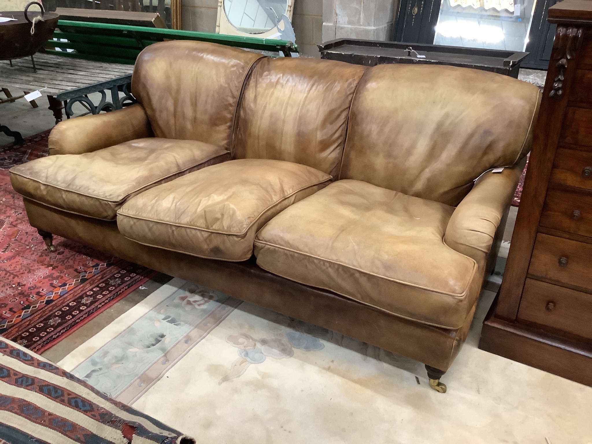 A Howard style pale brown leather three seater settee, length 200cm, width 110cm, height 80cm